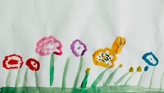 Kids painting flowers with water colors.