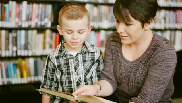 Mother reading to her son as he listens intently. Books in the background are slightly blurred creating the perfect atmosphere to instill a lifelong love of reading. The 3 - 6 year old boy is engaged, happy, the moment is captured in this photo creating a lifelong memory. 

https://www.awcreativeut.com
https://www.instagram.com/AwCreativeUT/
https://www.citystorageif.com/
https://www.etsy.com/shop/AwCreativeUT

#AwCreativeUT #awcreative #AdamWinger
