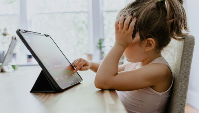 Young girl practicing kids coding on iPad